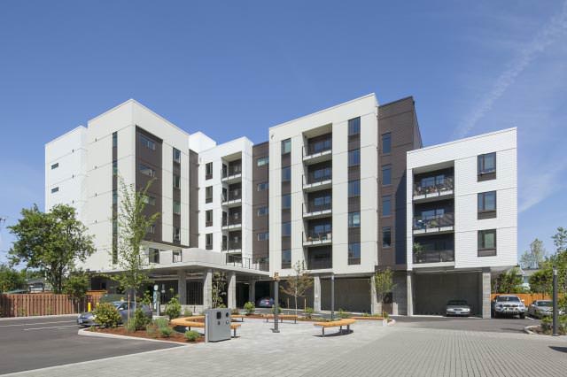 Photos show 60-unit, five-story building, including living wall with climbing plants. REACH Community Development Corporation/Sally Painter Photography